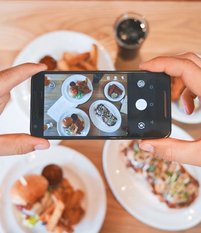 person taking picture of the foods