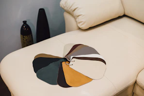 Various color swatches of sofa fabrics arranged neatly on a wooden table.