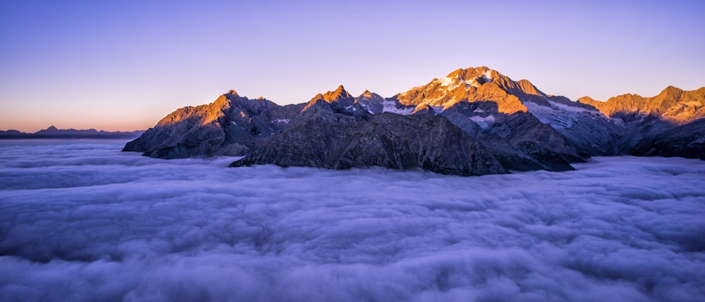 Montagne brune à côté d’un plan d’eau