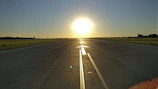A panoramic view of a newly restored runway stretching into the horizon at dawn, ready for takeoff.