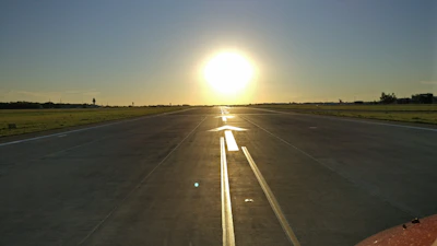 A panoramic view of a newly restored runway stretching into the horizon at dawn, ready for takeoff.