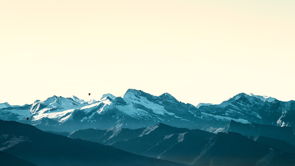 snow covered mountain under white sky during daytime