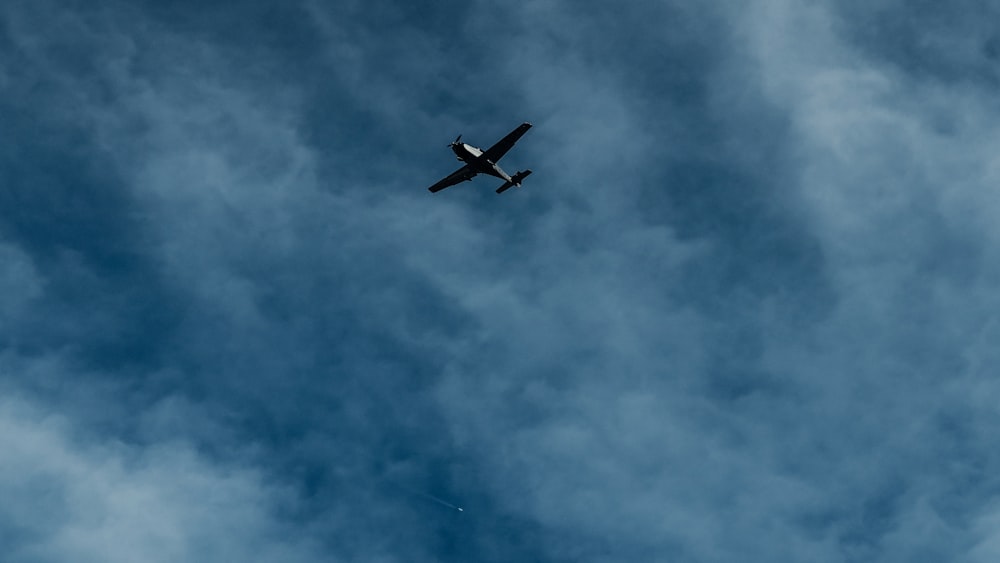 silhouette of airplane flying at daytime