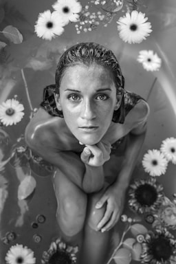 portrait photography,how to photograph woman in flower bath in black and white; grayscaled photo of woman