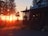 A family enjoying a sunset view from a rustic cabin porch.