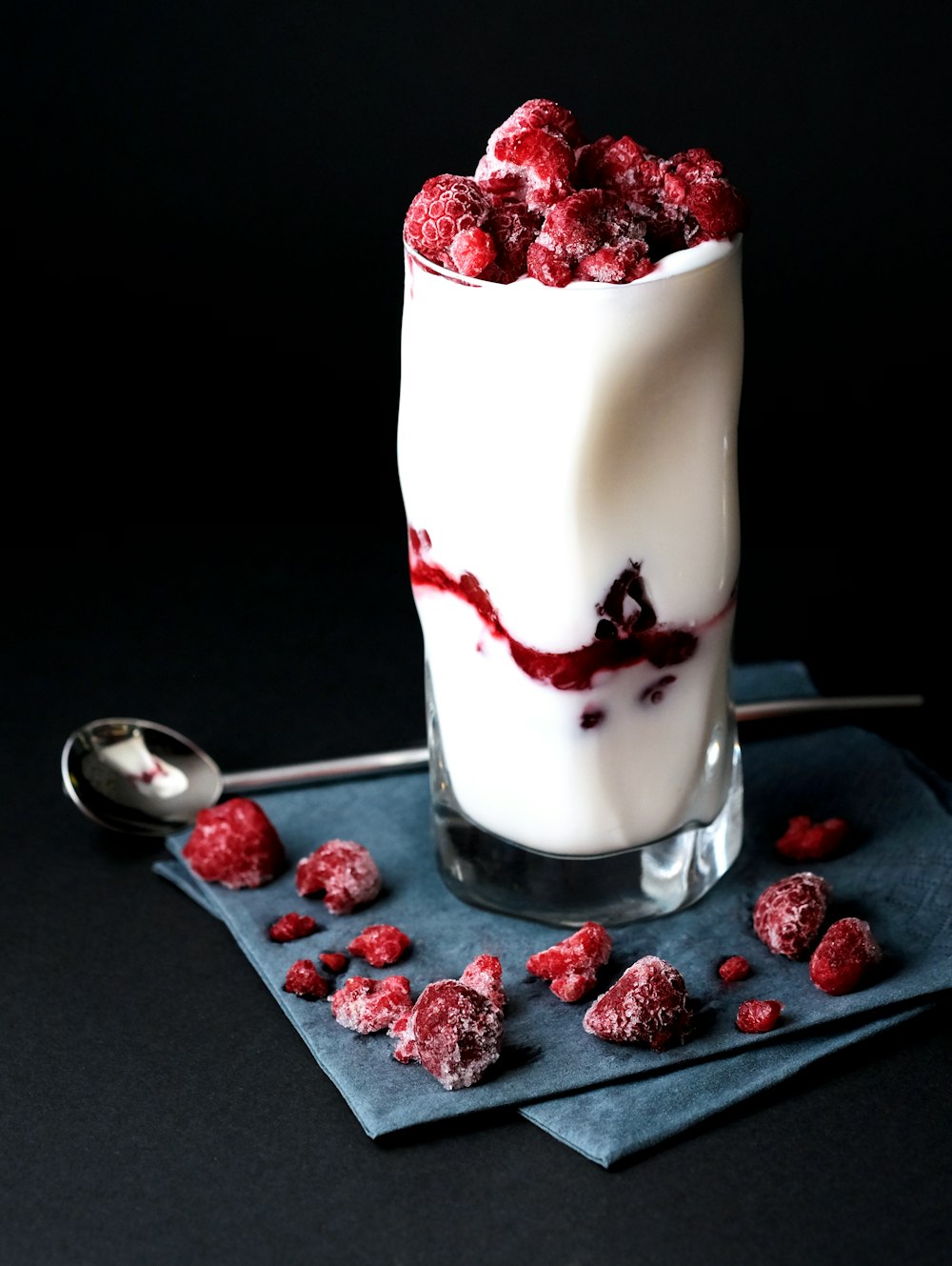 red raspberries on clear drinking glass