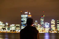 Silhouette of a man looking at a glowing city skyline symbolizing future goals