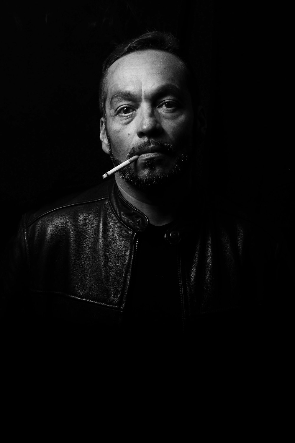 man wearing black leather jacket