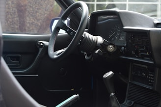 Close-up of a taxi meter and steering wheel inside the car.