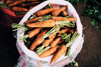 Bright assortment of dehydrated carrots, tomatoes, and bell peppers spilling from a burlap sack