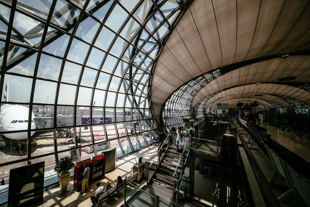 people walking and sitting inside the airport