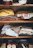 A wooden shelf holds neatly folded clothes, including sweaters with patterns, button-down shirts, and other garments. The top two shelves contain a mixture of casual and formal wear in various colors. The bottom shelf displays a few small containers and accessories.