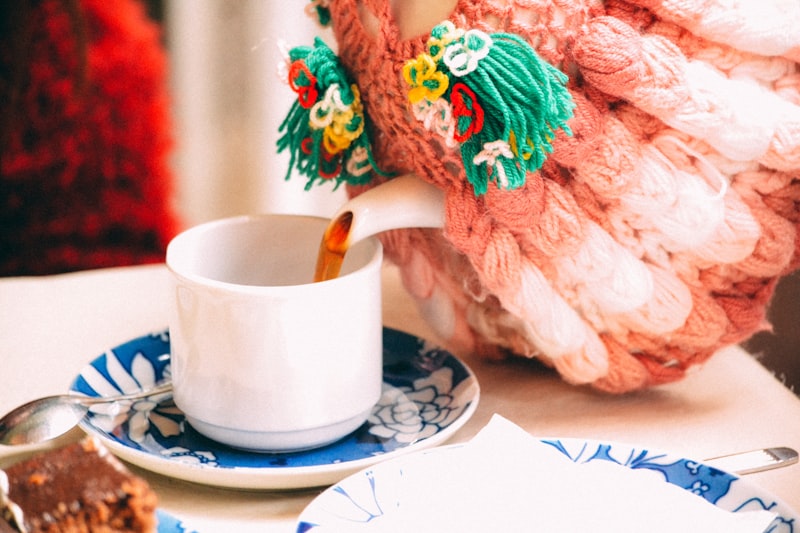 selective focus photography of person pouring teacup