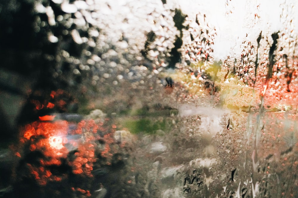 a view of a street through a rain covered window
