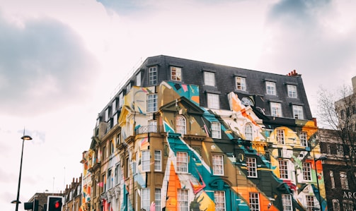 low-angle photography of building with art painting