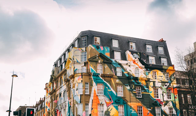 A Shoreditch building covered corner to corner in a large, colourful abstract street art mural.