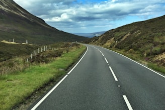 A finished road winding through a scenic landscape.