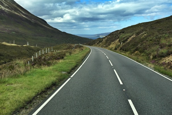 A finished road winding through a scenic landscape.