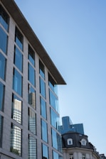 Cinematic view of sleek glass buildings in Brussels' European quarter reflecting the sky.
