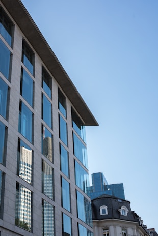 Cinematic view of sleek glass buildings in Brussels' European quarter reflecting the sky.