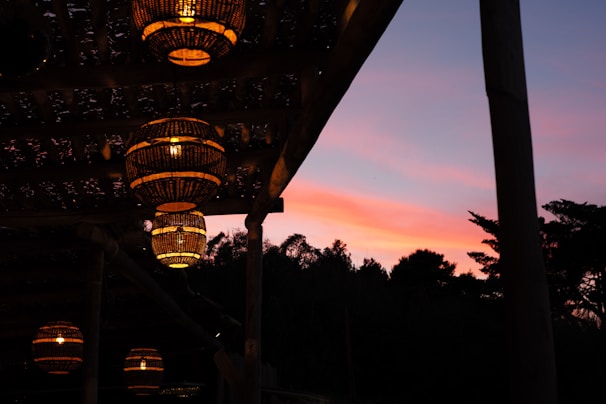 Elegant lanterns casting warm light over an outdoor evening gathering.