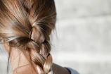 Elegant braiding certification class in session, highlighted by warm gold brush stroke effects