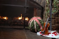 Rachel seated by a cozy fireplace, her harp resting beside her as she prepares for a performance.