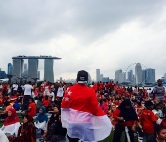 An aerial view of a large crowd gathered for a national celebration, with red accents visible.