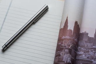 A close-up of a sophisticated pen on a notepad with a corporate logo.