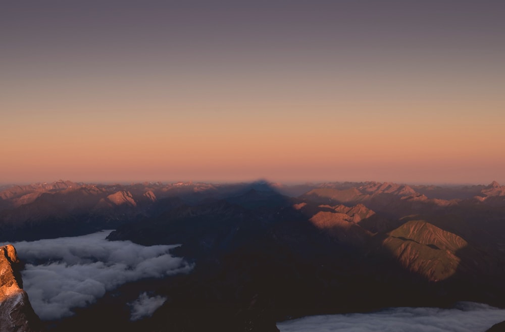 mountains and clouds during sunset