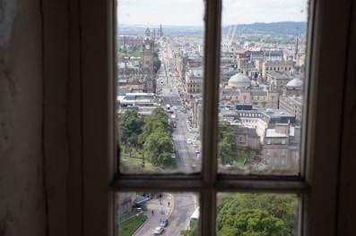 City view from a window overlooking busy streets and cafes.