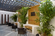 Outdoor terrace featuring clean lines, natural materials, and lush greenery.