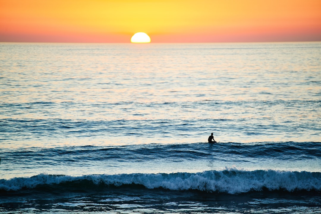 person surfing during sunset