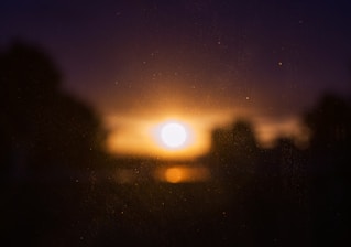 A wide-frame cinematic shot featuring a softly glowing golden-hour scene with subtle film grain, evoking warmth and emotion.