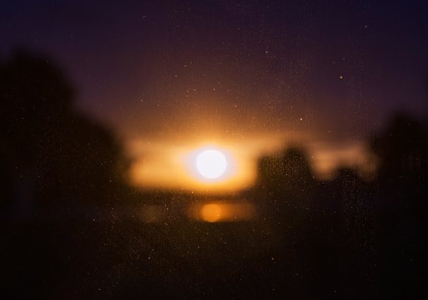 A wide-frame cinematic shot featuring a softly glowing golden-hour scene with subtle film grain, evoking warmth and emotion.