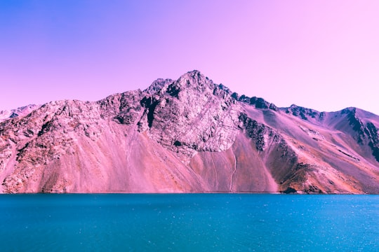 mountain beside body of water in El Yeso Dam Chile