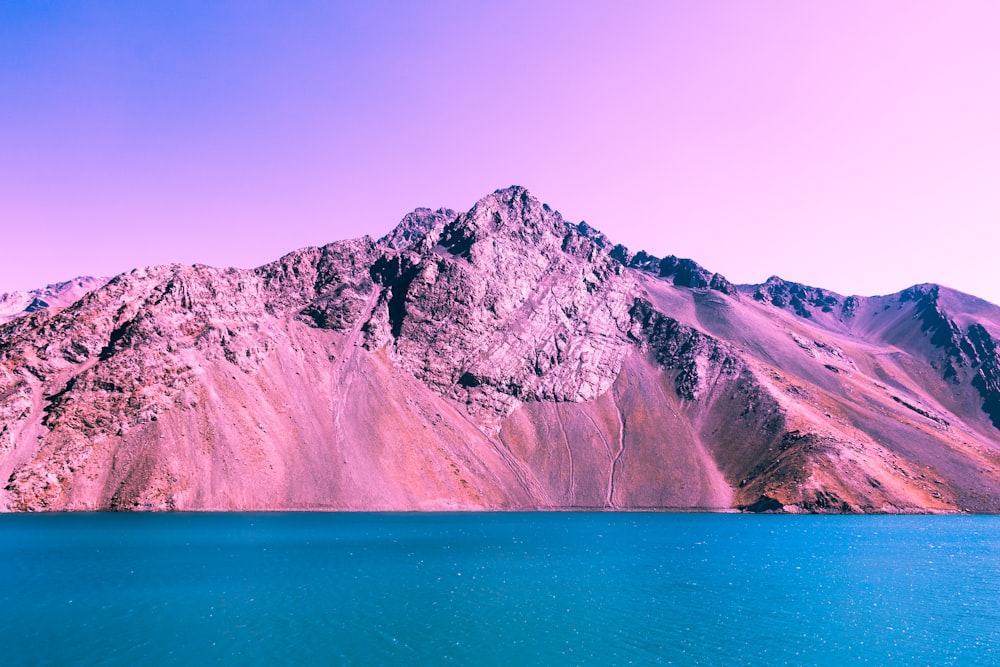 mountain beside body of water