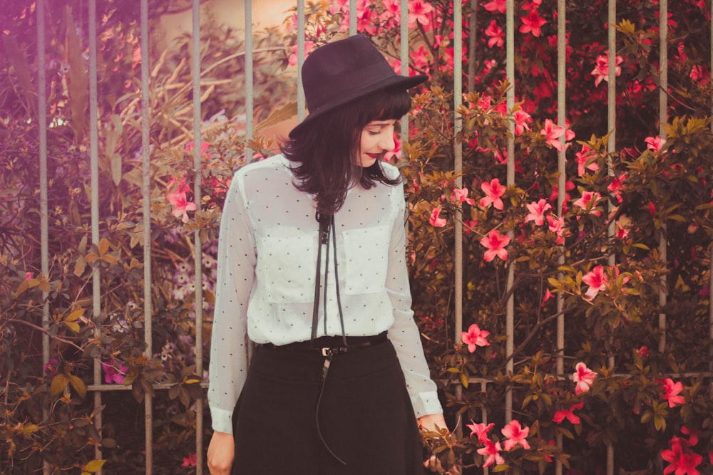 a woman wearing a hat and a white shirt