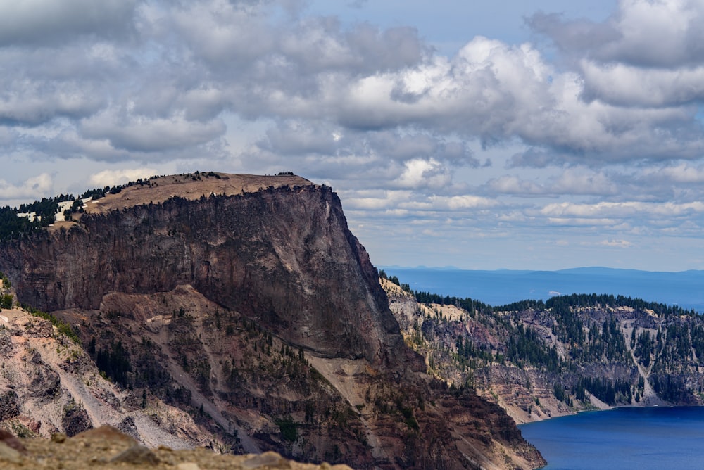 aerial photo of mountain near body of water