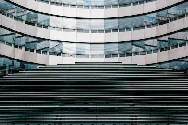 Facade of a building featuring sleek aluminum frames and tempered glass panels.