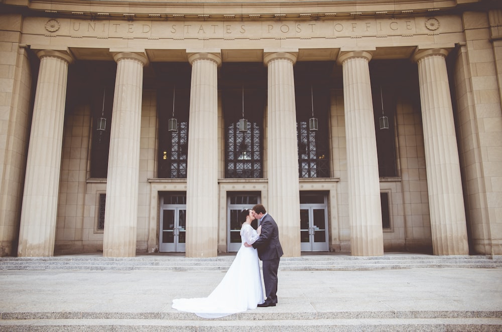 man kissing woman