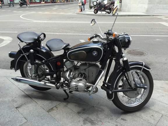 Photo of a sleek, recently sold vintage motorcycle parked on a city street.