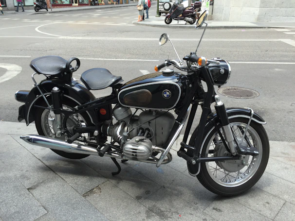 A classic vintage motorcycle gleaming with chrome details on a city street.
