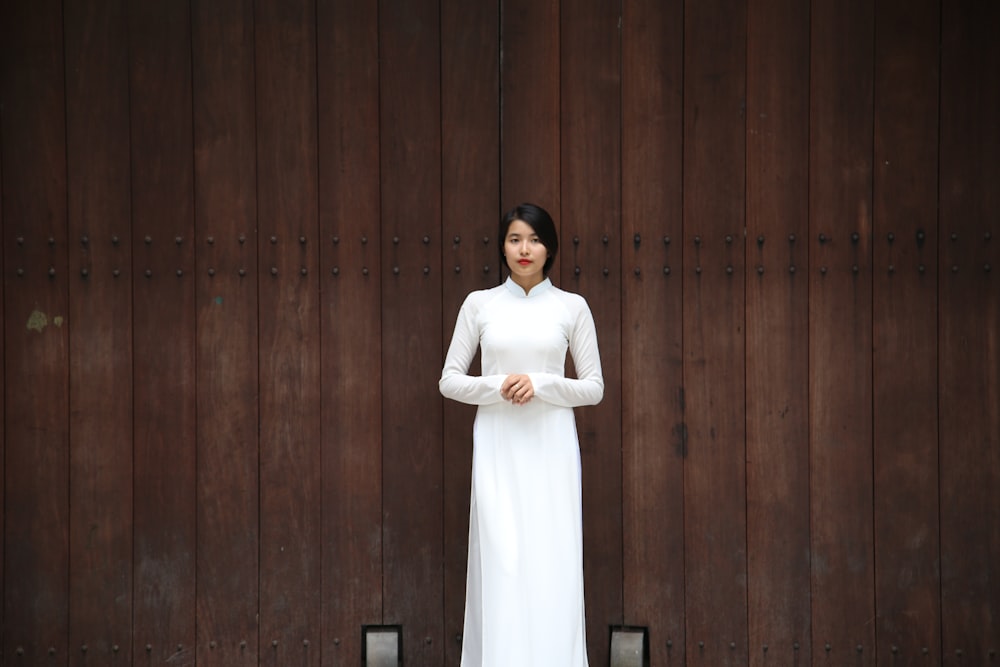 woman standing near brown wall