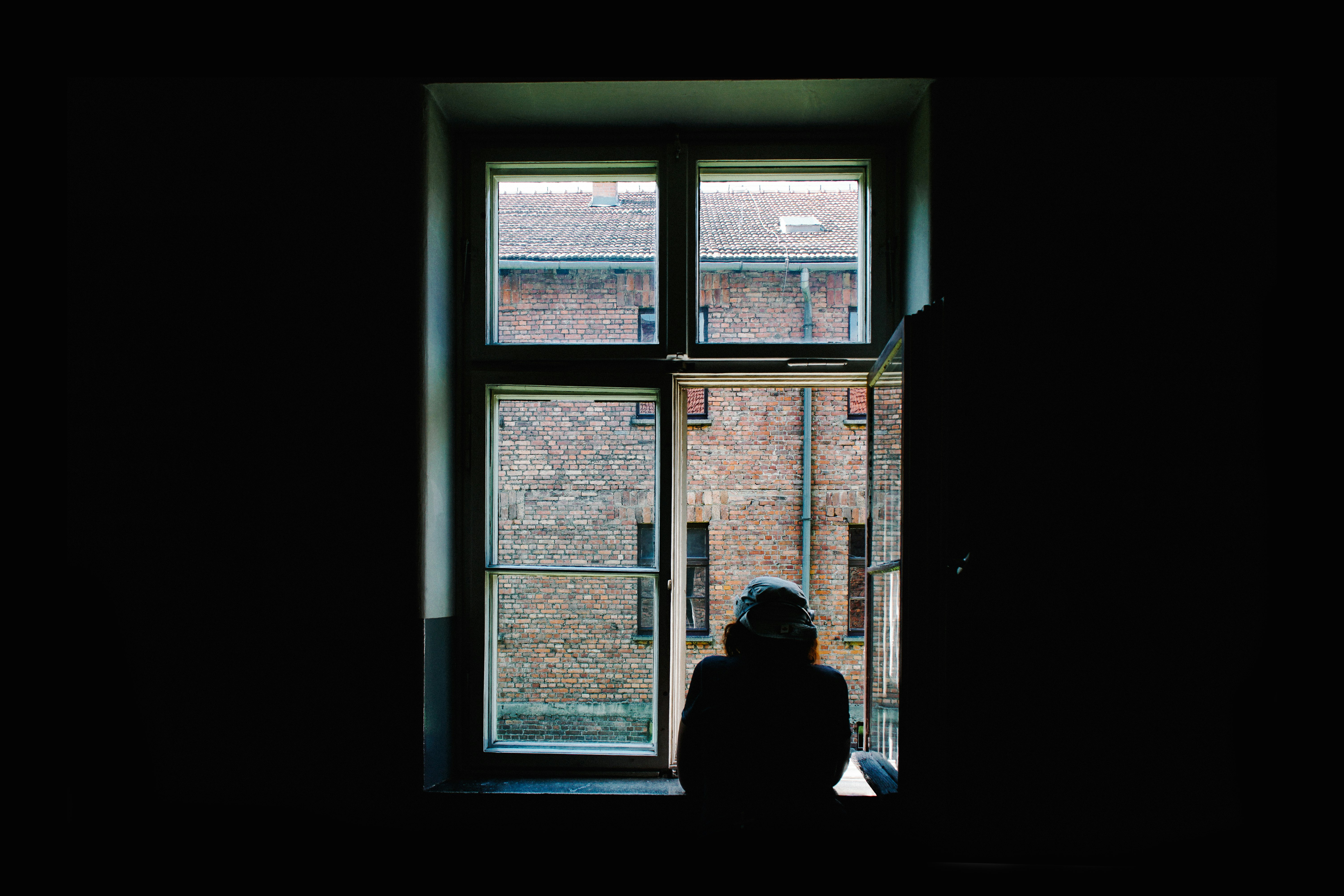 person standing in front of open window