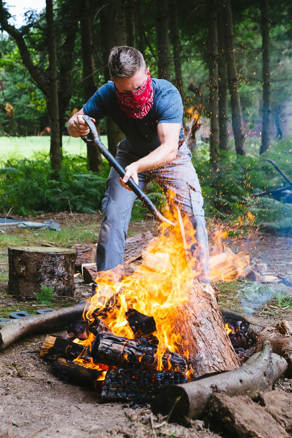 a man using a stick to put out a fire