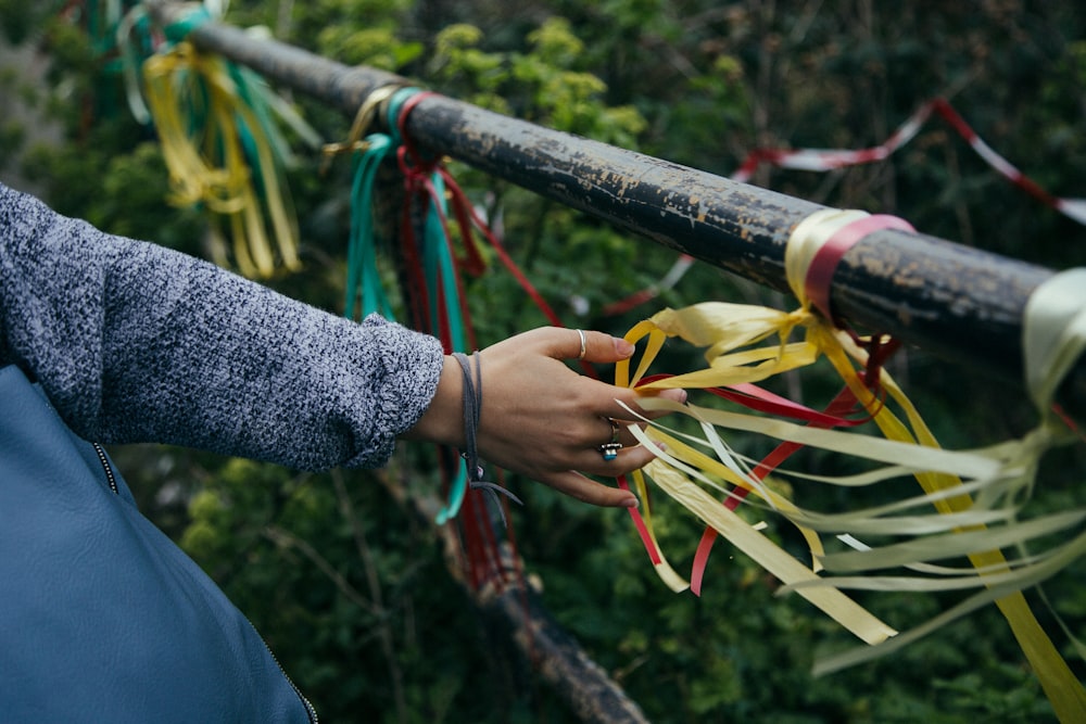 person holding white and red rope