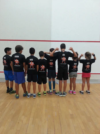 Children lined up ready for a tumbling class in colorful sportswear