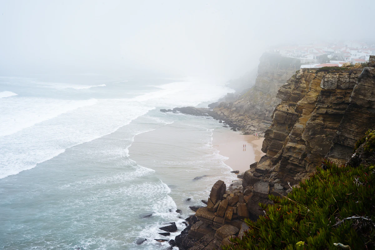 Aerial view of the rugged Big Sur coastline where cliffs meet the Pacific Ocean