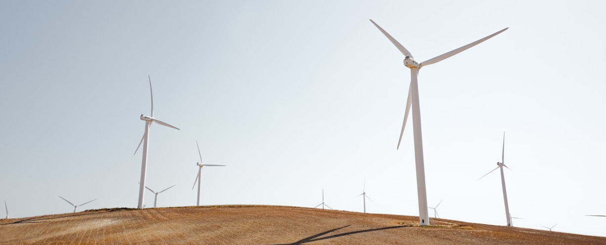 white electric windmills during daytime